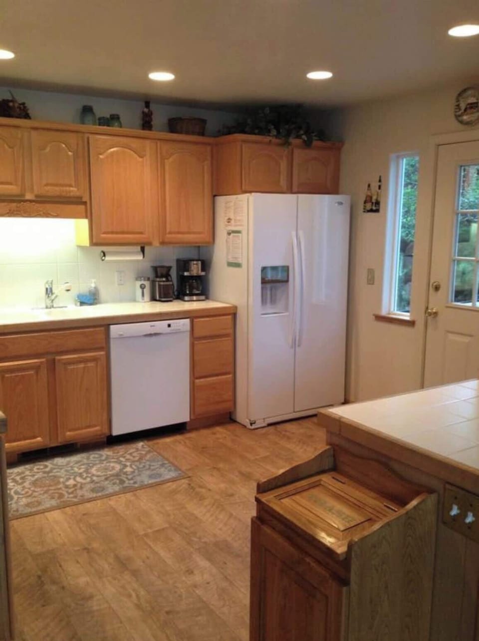 Kitchen with dishwasher, fridge, icemaker and water dispenser.
