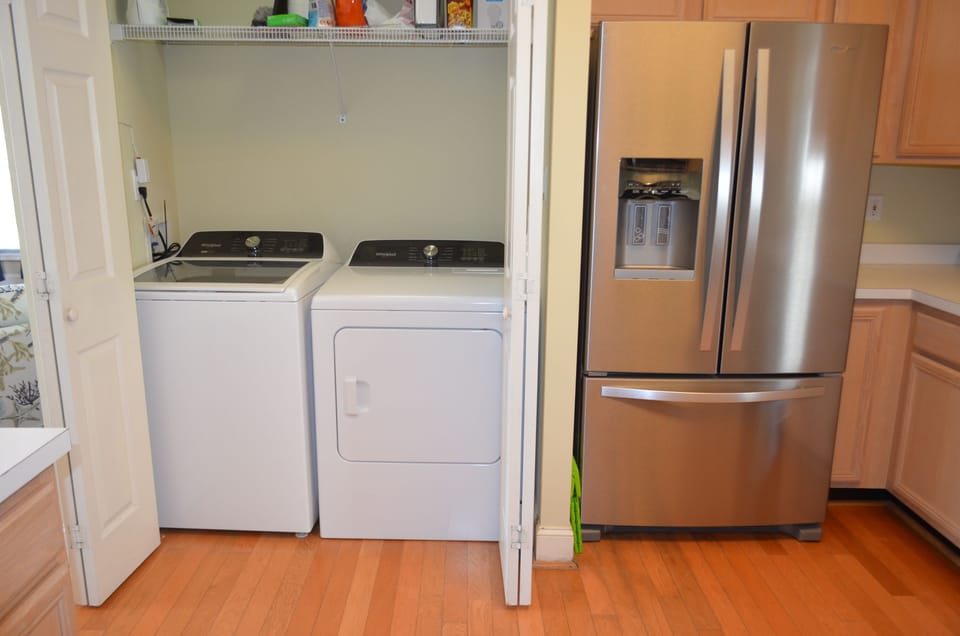 Laundry Located Downstairs in Kitchen Closet