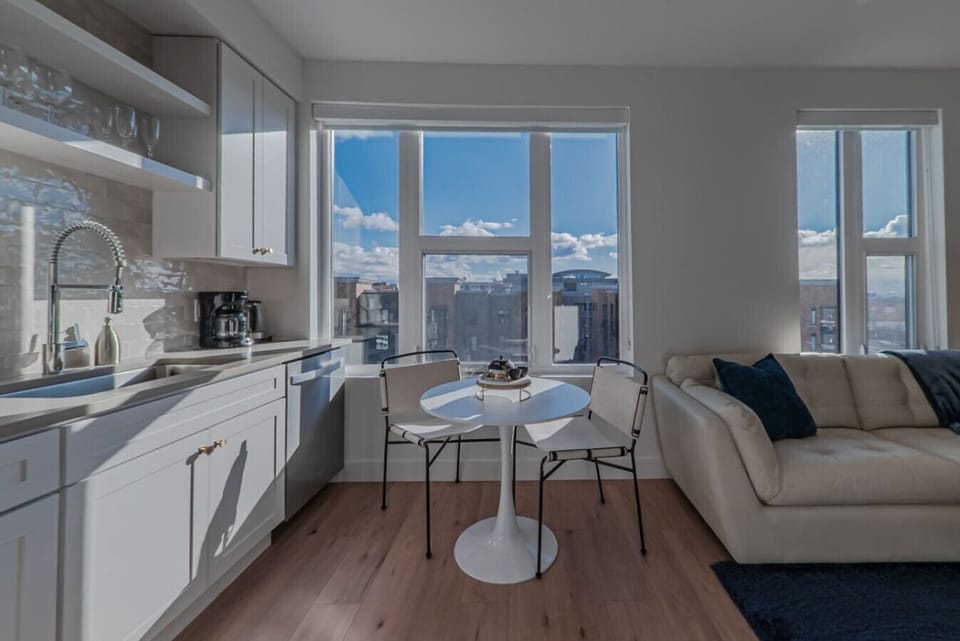 Beautifully designed living room. 65` TV, comfy sofa and amazing views of mountains and city skyline.
