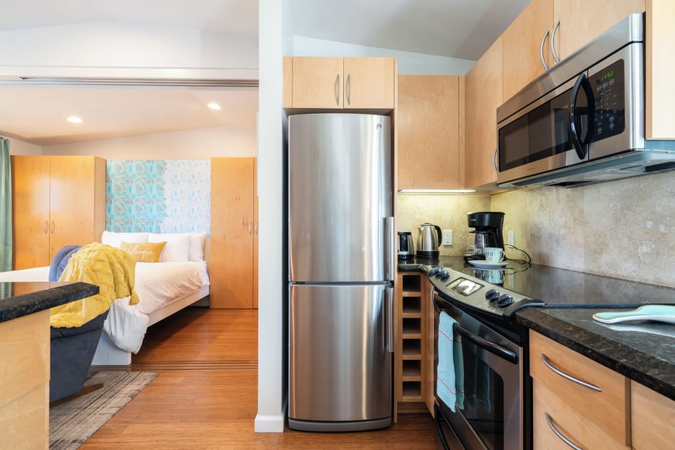 Full chef's kitchen with stainless steel appliances.  All pots and pans, dishes, equipment needed