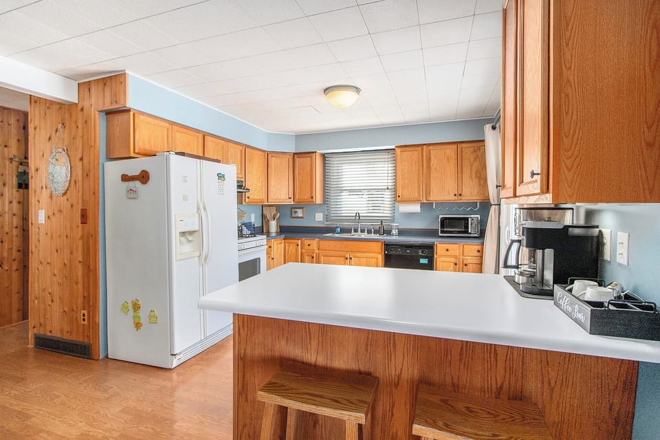 Full kitchen with gas range, dishwasher, and coffee bar
