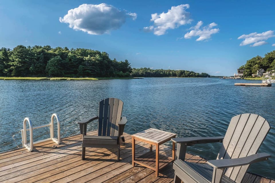 Relax on the deck with Adirondack chairs overlooking calm waters