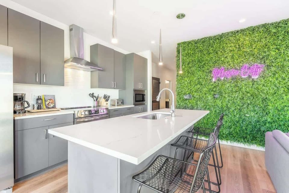 Sleek design with modern appliances and vibrant greenery for culinary adventures!