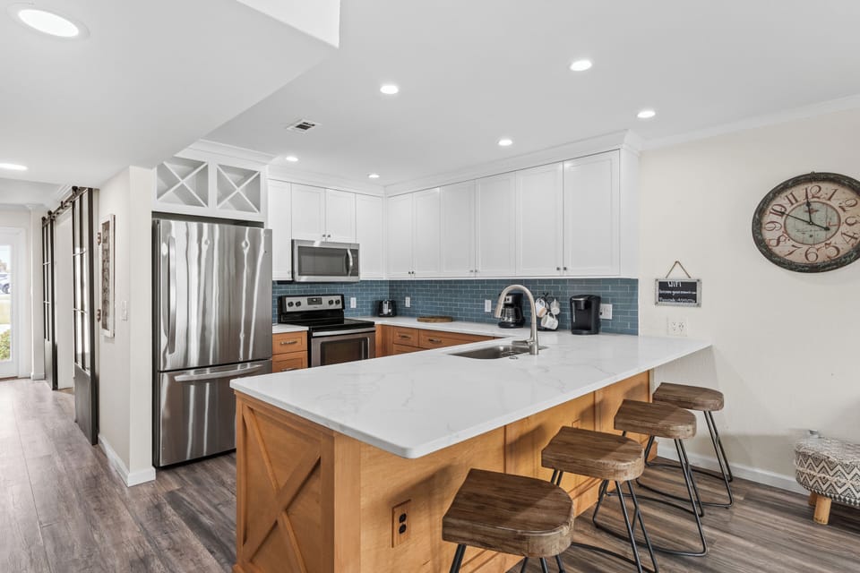 Your fully equipped kitchen features modern appliances, stylish island seating, and everything needed for memorable meals together.