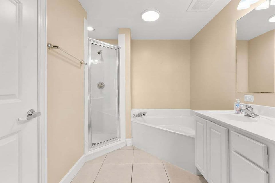 Bright and airy bathroom with a walk-in shower and a bathtub.