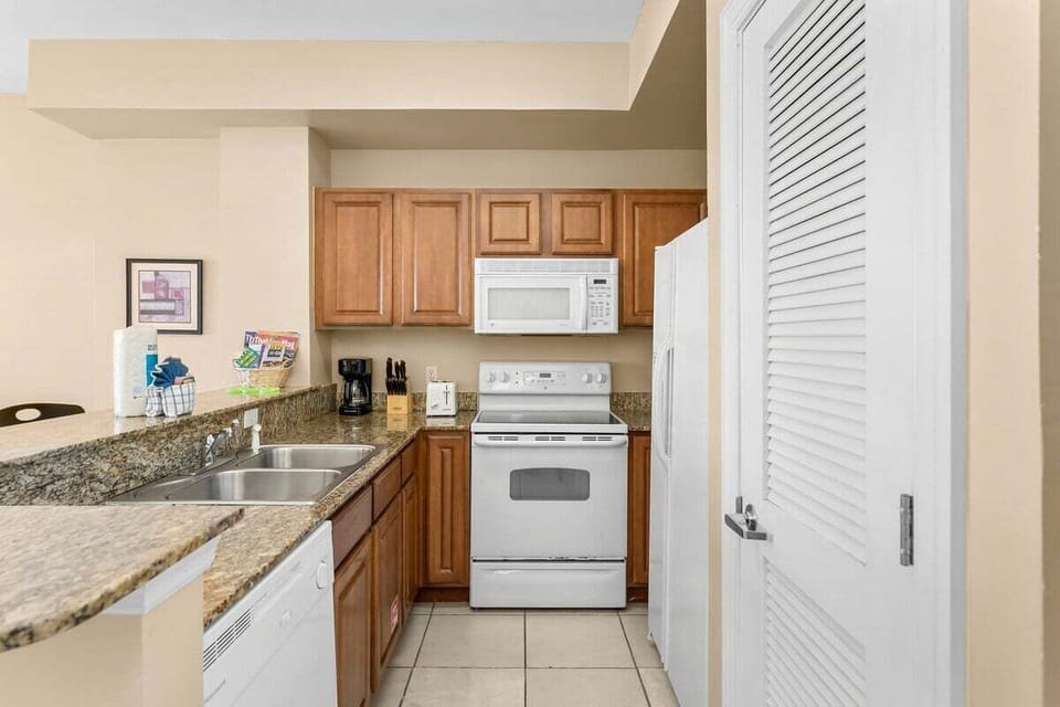 Well-equipped kitchen with a microwave, stove, and refrigerator.