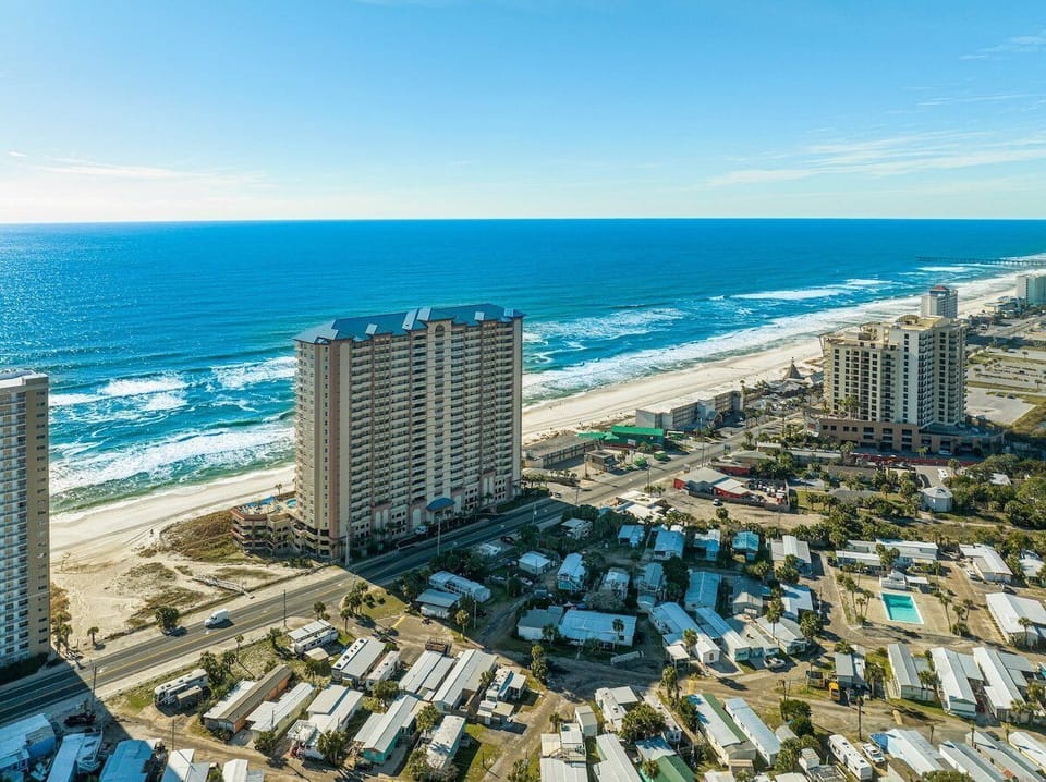 Panoramic view of the ocean, breathtaking beachfront property  and a pool