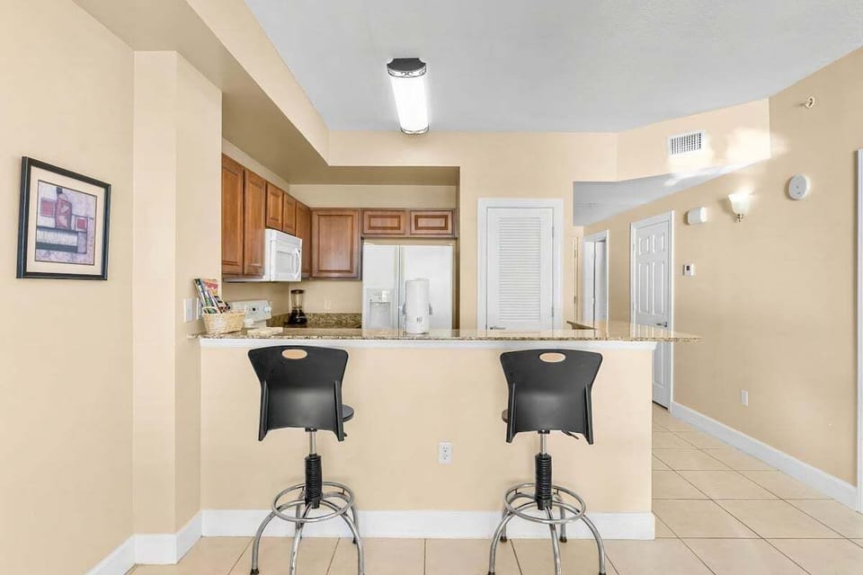 Fully equipped kitchen with breakfast bar seating, perfect for cooking and dining in.