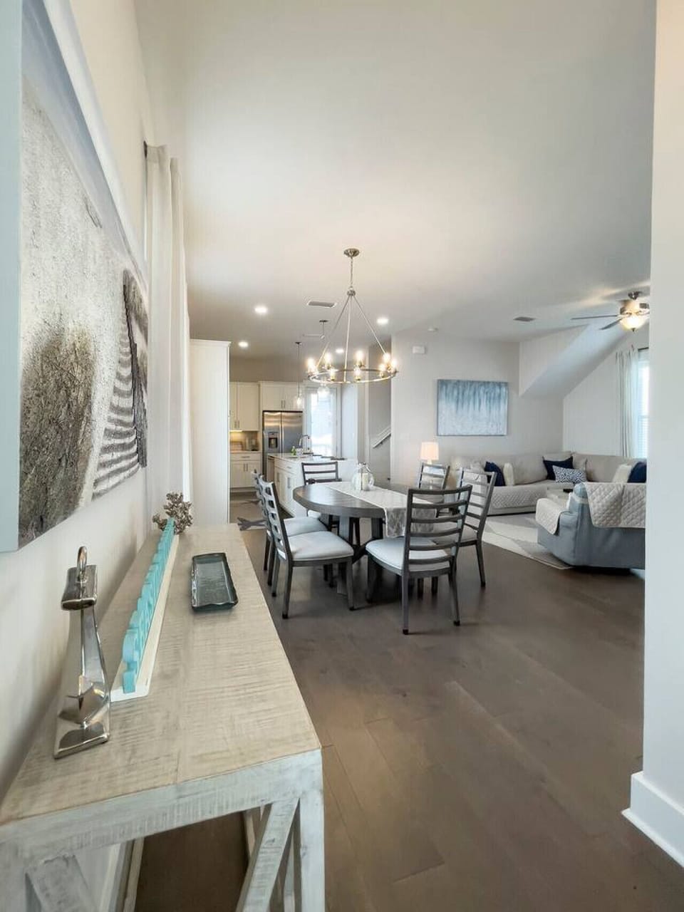 Modern open-concept living with marble counters, spacious dining, bar seating, and a comfy lounge with smart TV + soundbar.