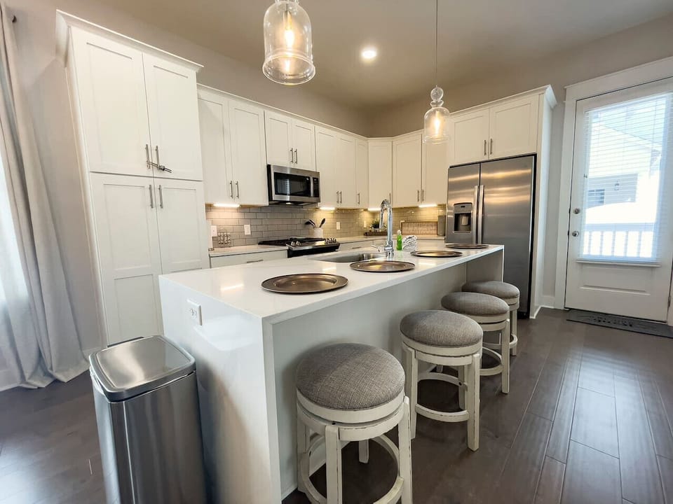 Gorgeous kitchen with marble counters, pantry cabinet, newer stainless steel appliances, and essential cooking basics.