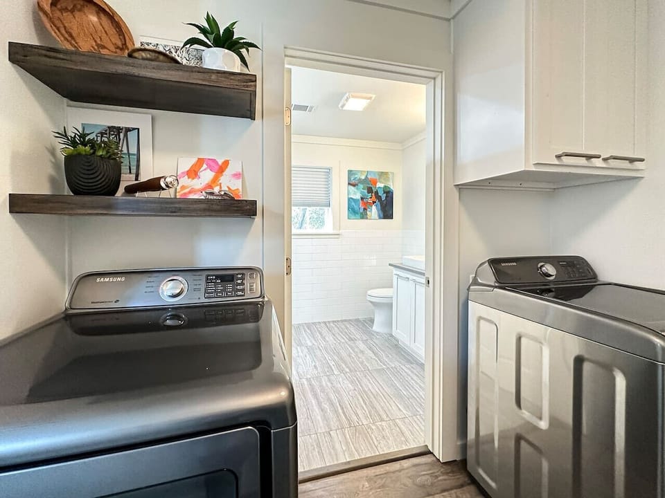 Full size washer and dryer set is in the corridor by the bathroom.