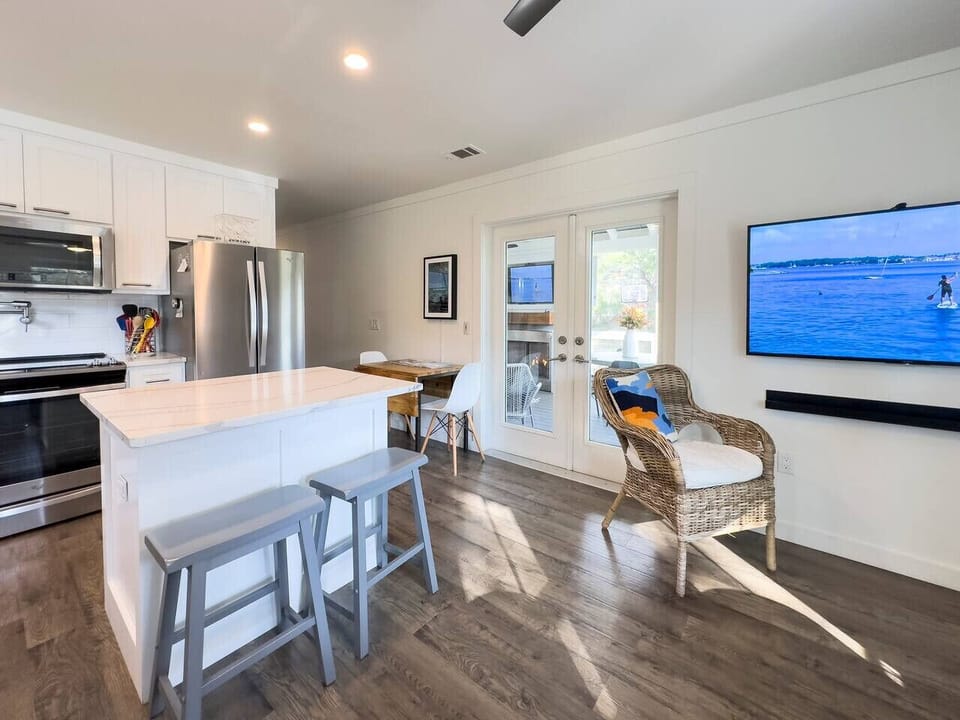 Flat screen Smart TV is visible from the living area and kitchen.