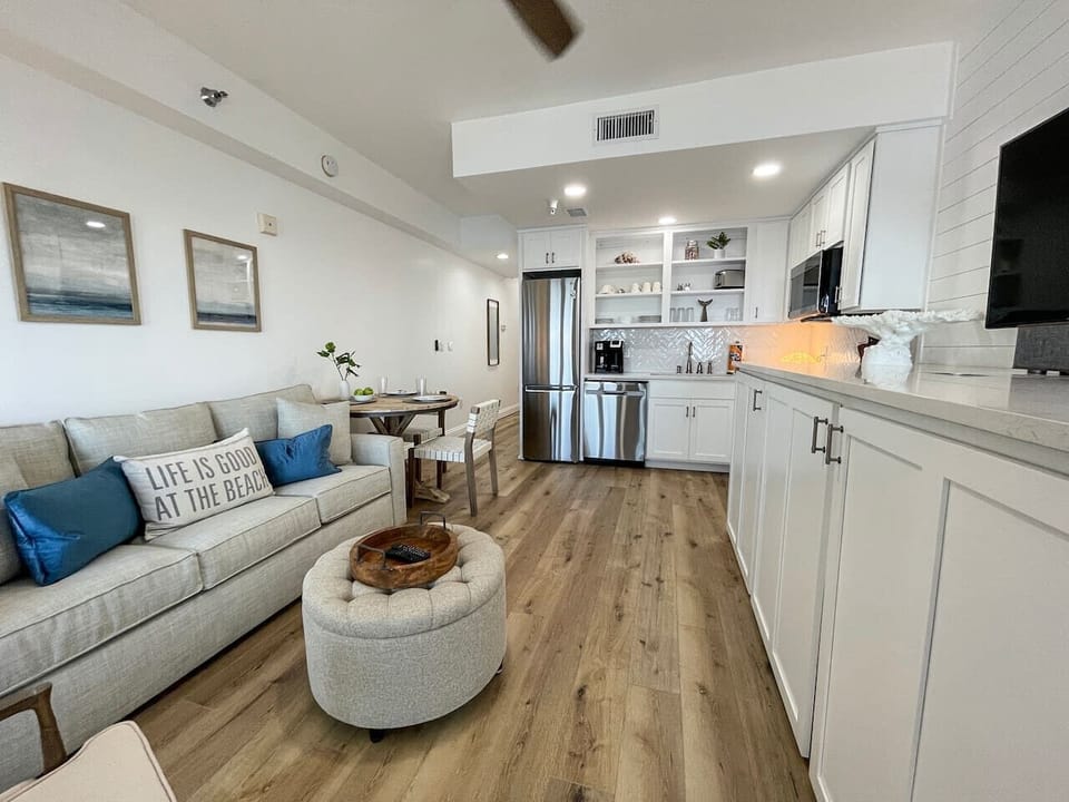 Living area houses a plush queen size sleeper sofa and flat screen tv.