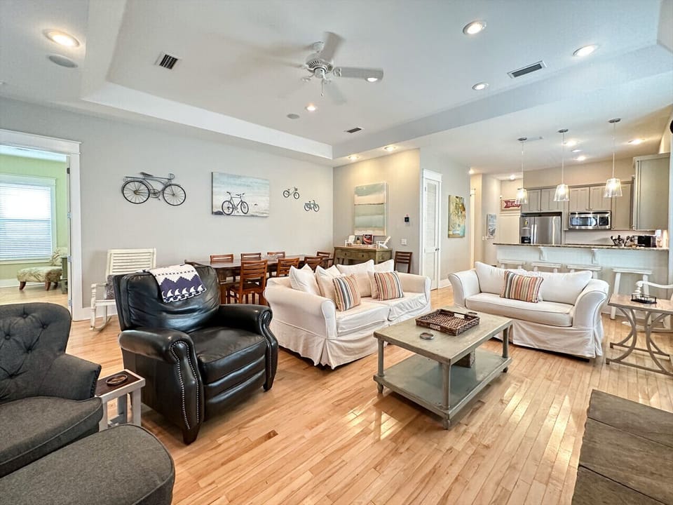Spacious open living room with plenty of comfy seating and a seamless flow into the dining and kitchen areas.