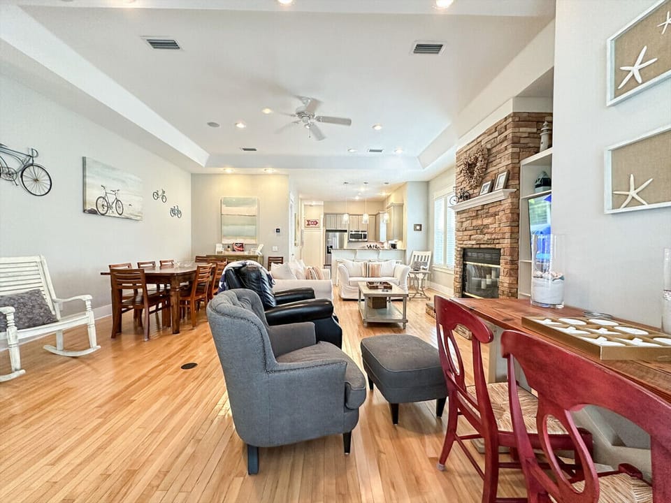 Spacious open living room with plenty of comfy seating and a seamless flow into the dining and kitchen areas.