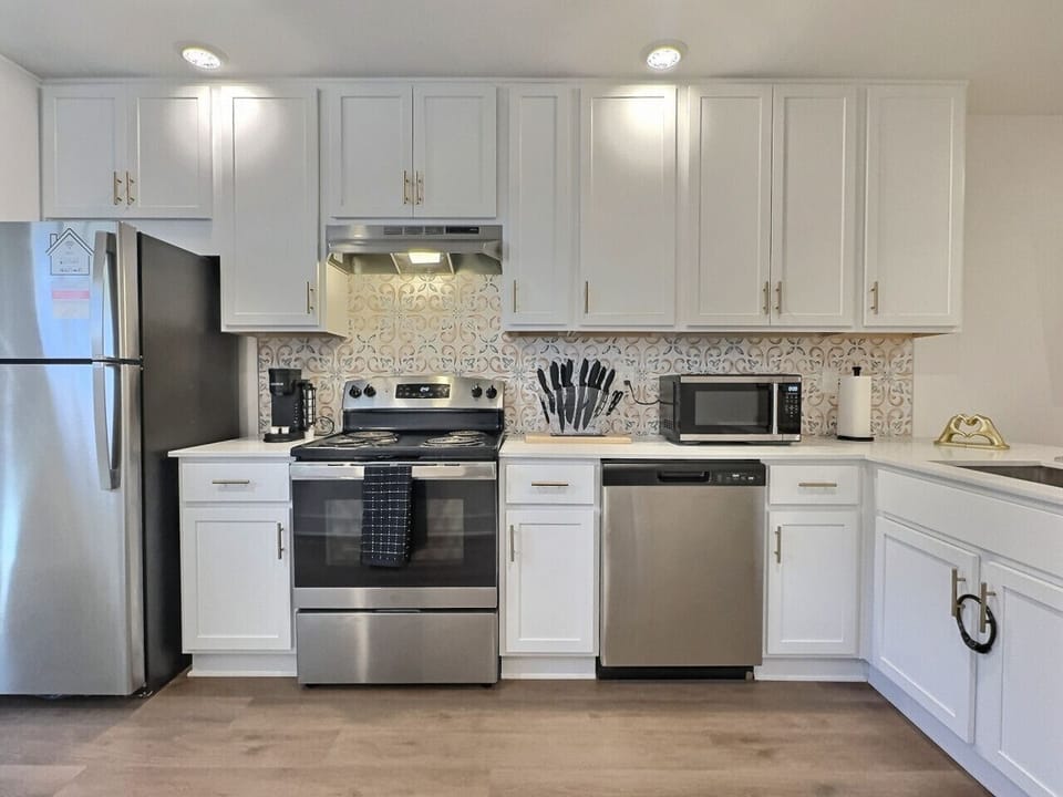 Ample cabinet storage and a clean countertop create an inviting atmosphere, perfect for meal preparation.