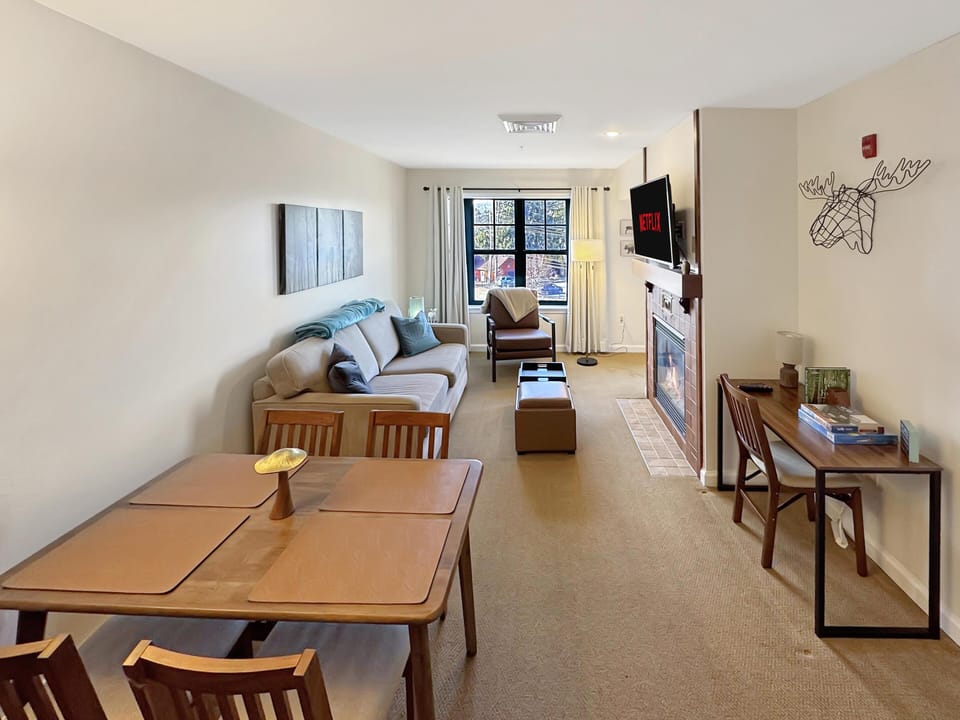 Cozy living and dining area with city views and natural light