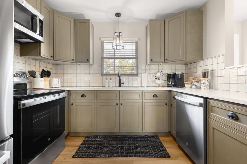 A kitchen that has it all -- coffee station, cookware, silverware, dinnerware.