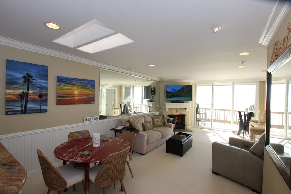 Living room with fireplace and gorgeous view of ocean out that slider.