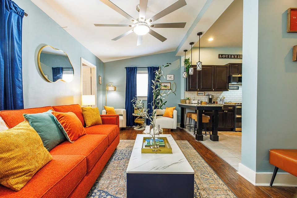 LIVING ROOM COLORFUL DECORATED ADJACENT PLUSH SEATS-CENTRAL HEATING & AIR UNITS