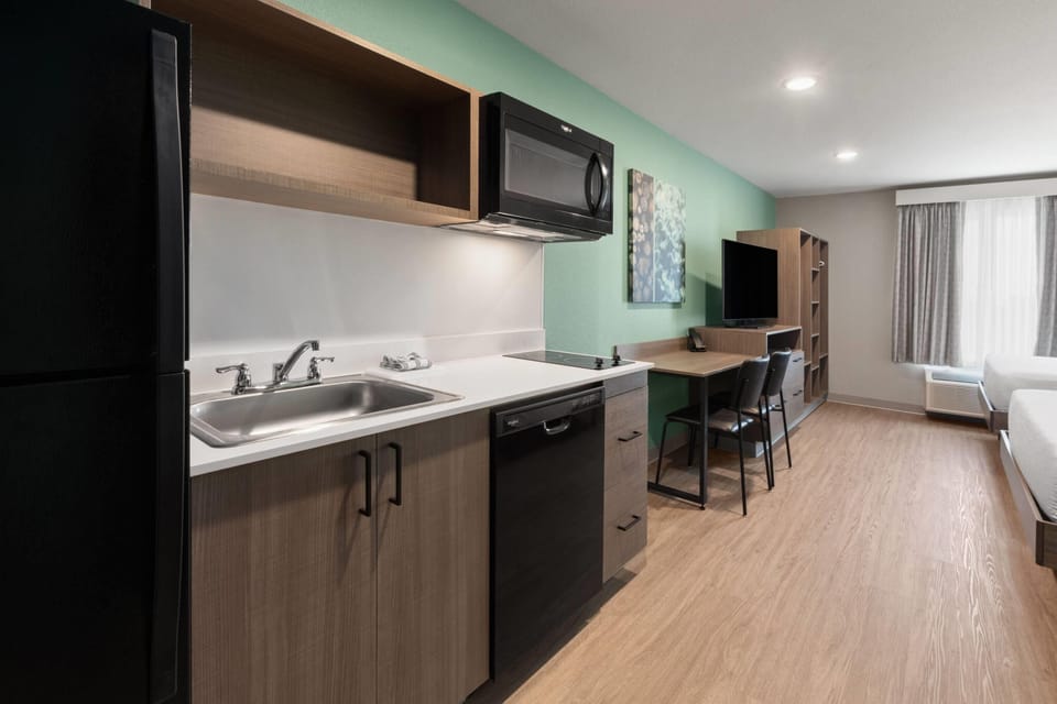 Suite, 2 Queen Beds, Non Smoking | Desk, laptop workspace, WiFi (free), bed sheets