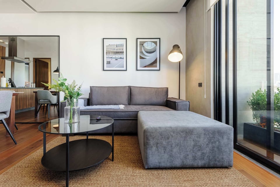 Spacious open-plan living and dining area with minimalist décor and natural light.