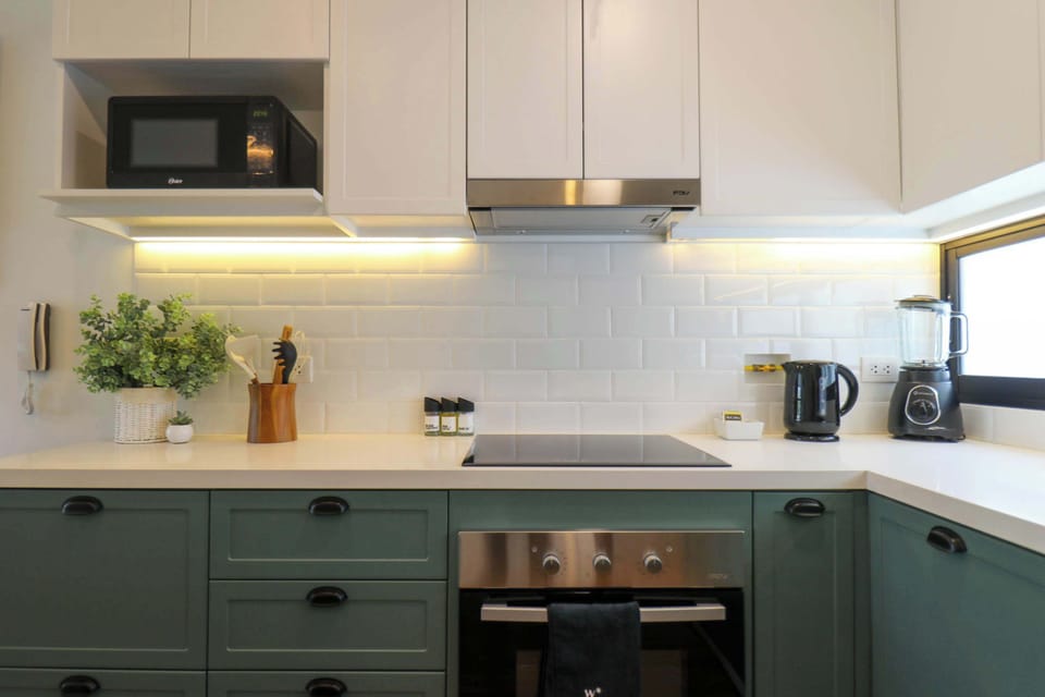 View of kitchen appliances and cabinets.