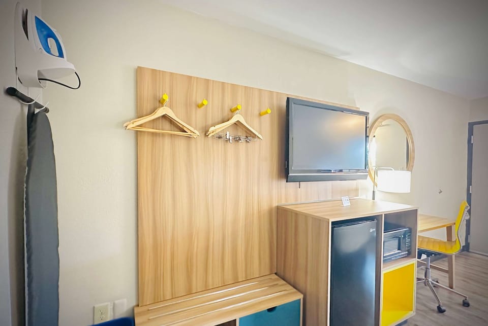 Desk, laptop workspace, blackout drapes, iron/ironing board