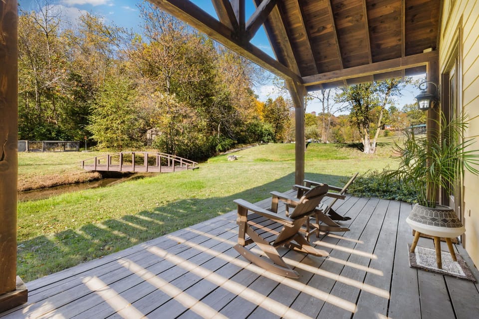 Gorgeous patio covered in greenery with a porch swing, dining table, and an outdoor shower (available in warmer months).