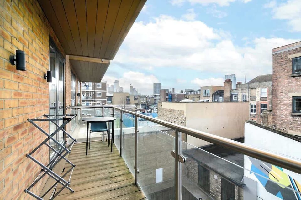 Private balcony with city views and seating area