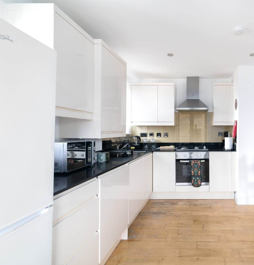 The open-plan kitchen is set within the living area and is fully equipped with all essential cookware, including pots and pans. Guests will find a fridge-freezer, dishwasher, microwave and oven, along with plates, mugs and glassware ready for use. 