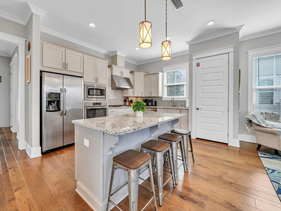 Your fully-equipped kitchen features granite countertops, stainless steel appliances, and a breakfast bar perfect for morning coffee or casual meals together.