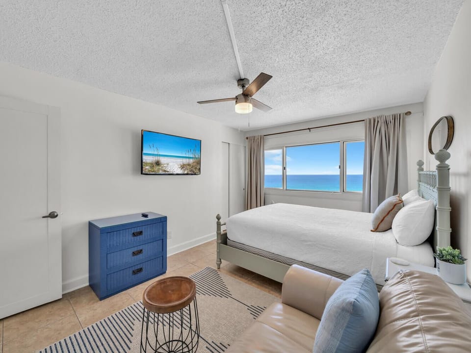 Wake to endless water views streaming through your bedroom windows, with comfortable coastal furnishings and modern amenities creating your perfect seaside retreat.