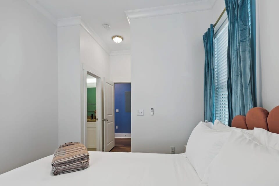 Neutral tones complemented by vibrant eye-catching details. This bedroom is equipped with its own private bathroom. 