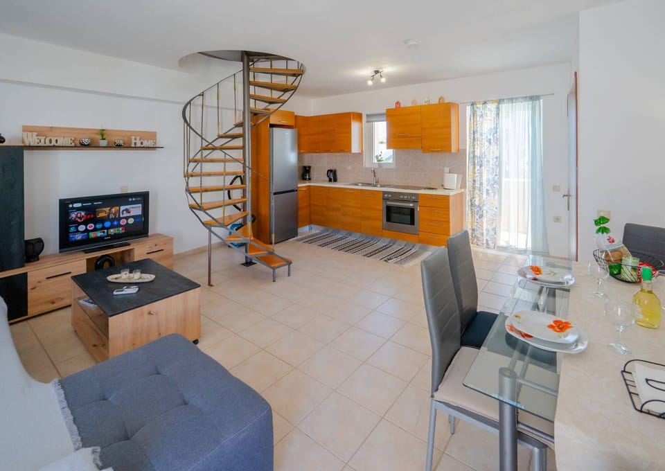 Entrance to the apartment. Living room, dining area, staircase to the bedrooms and kitchen.