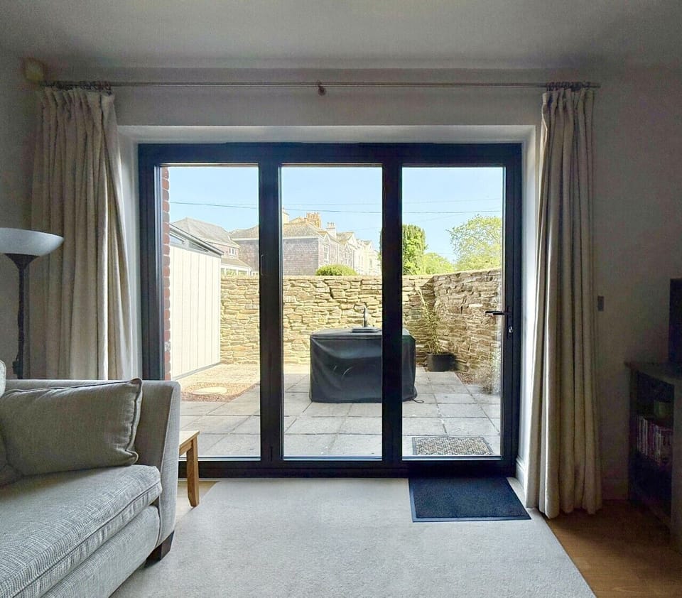 New bifold doors with access to courtyard garden with dining table and chairs
