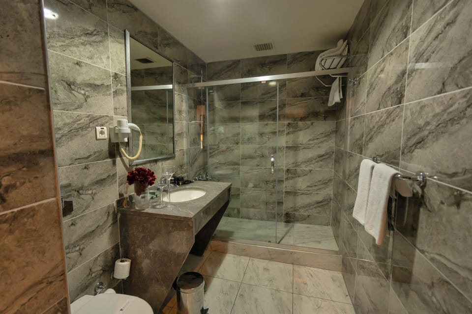 Designer toiletries, hair dryer, slippers, towels