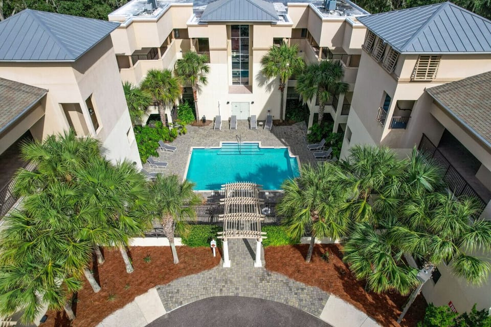 Enjoy access to the private pool surrounded by tropical landscaping.