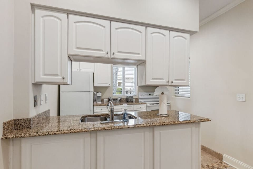 Fully stocked kitchen with everything you need, including a coffee maker and toaster.