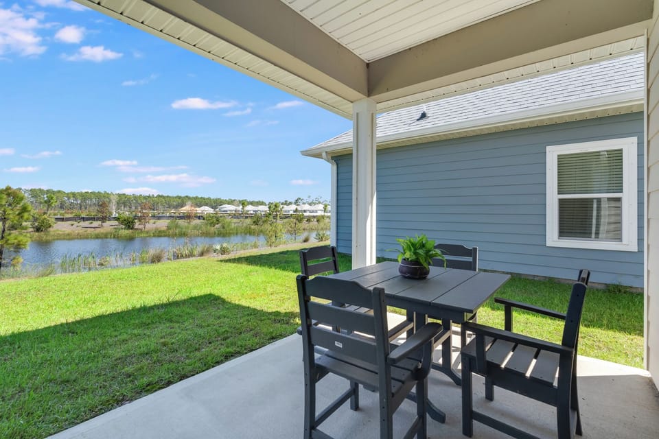 Enjoy morning coffee or evening meals at your private covered patio with stunning lake views and peaceful greenery stretching to the horizon.
