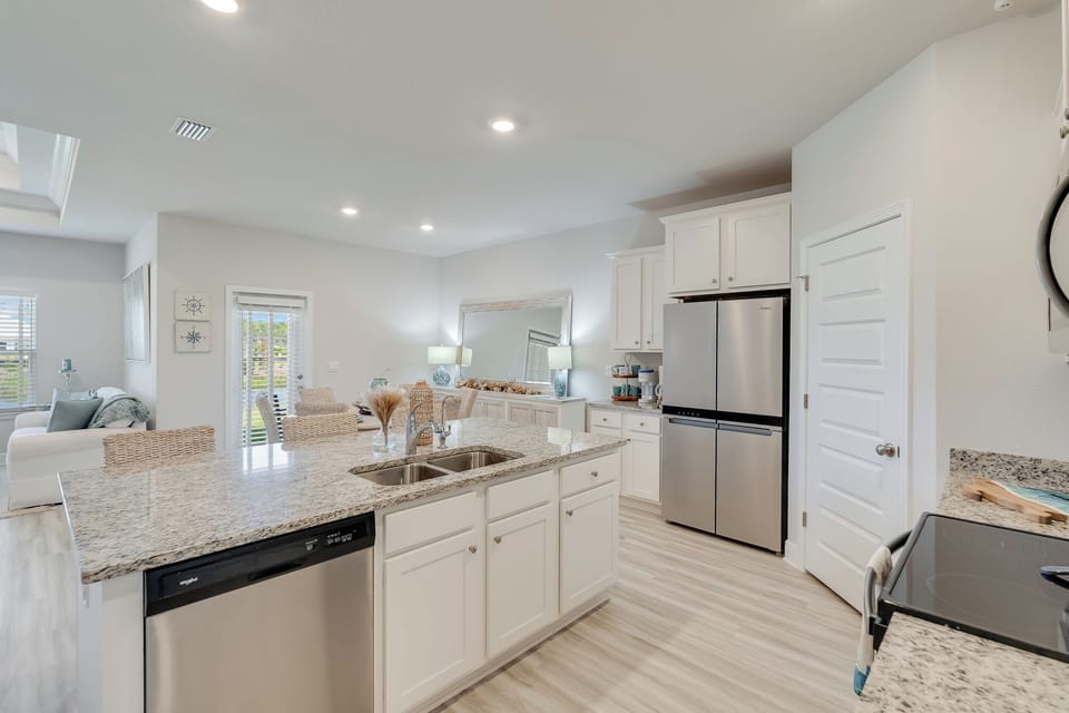 Your bright, open kitchen features granite counters, stainless steel appliances, and spacious island perfect for cooking memorable meals together.