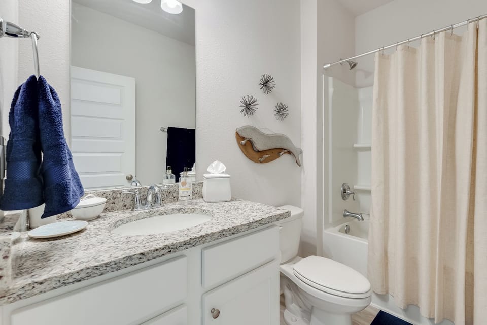 Your private bathroom features granite counters, plush towels, and a relaxing tub-shower combo for unwinding after exploring.