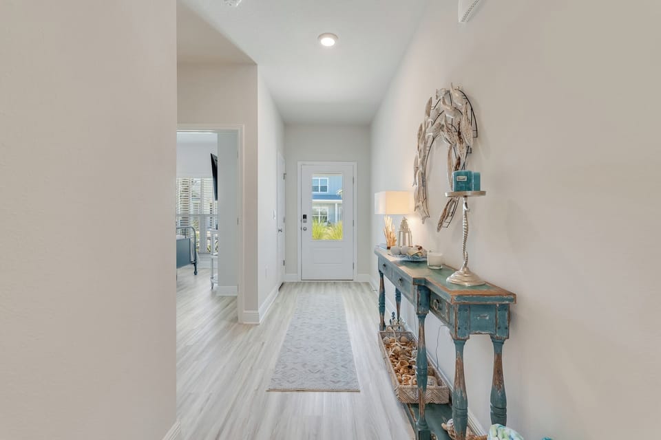 Step into your bright, welcoming entryway featuring coastal-inspired decor and charming touches that set the perfect vacation mood.