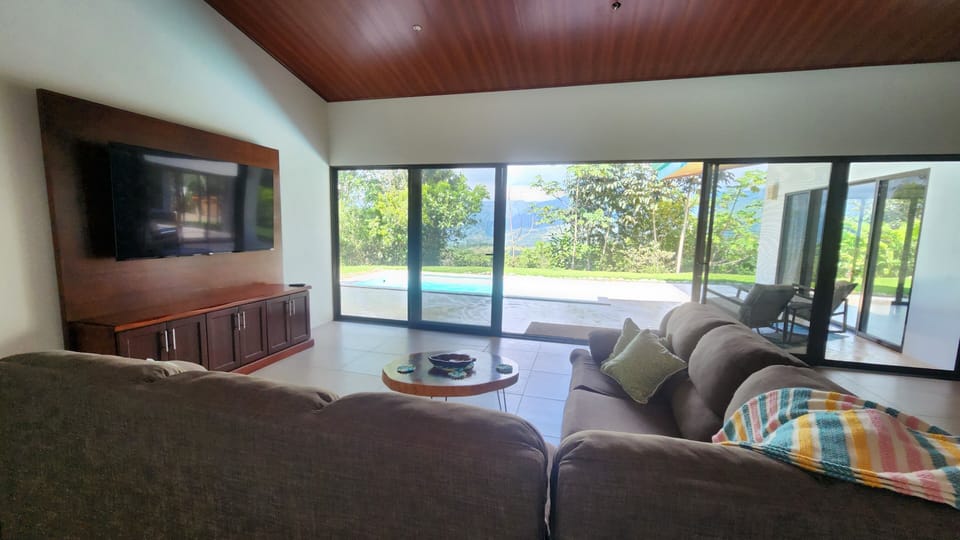 Living room open to the shaded pool area