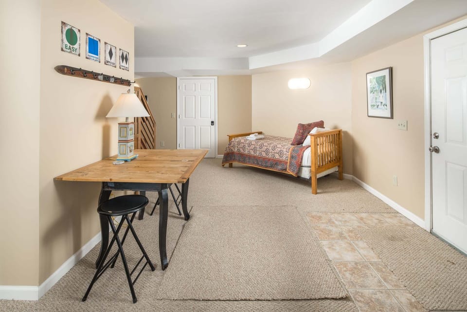 Lower-level family room with workspace and custom Twin-over-Twin bunk beds