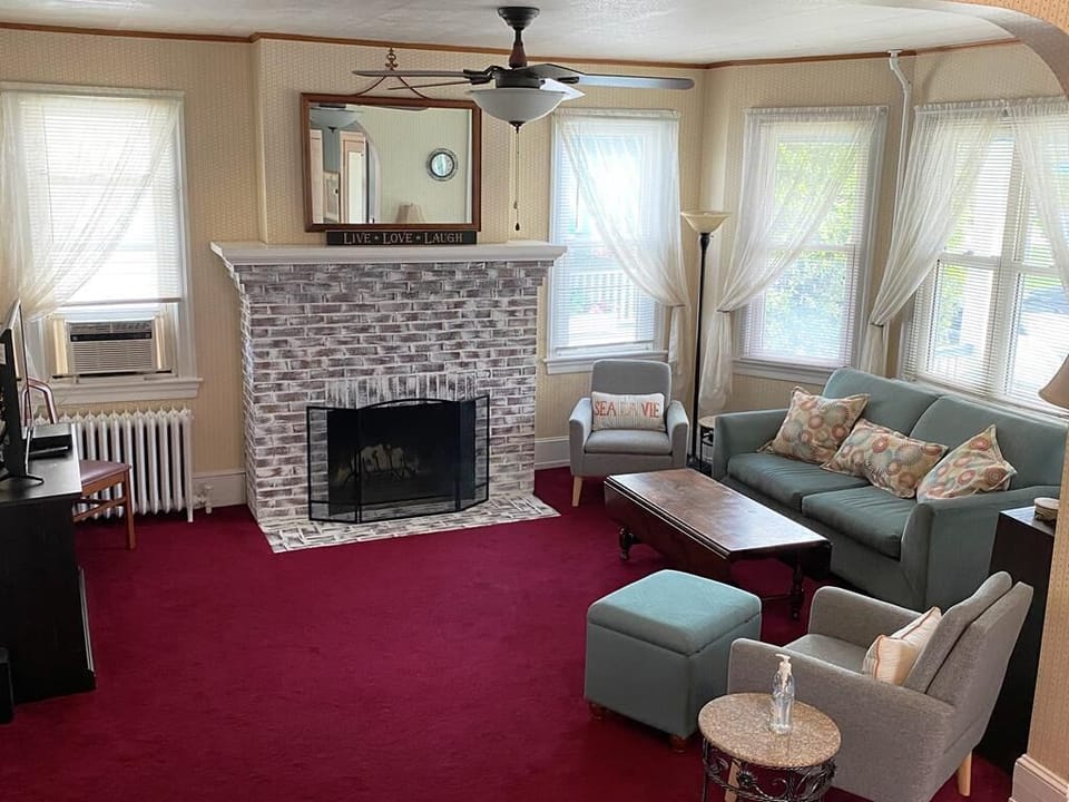 Inviting living room with a flat-screen TV, comfortable seating, and a fireplace for cozy evenings with your group.