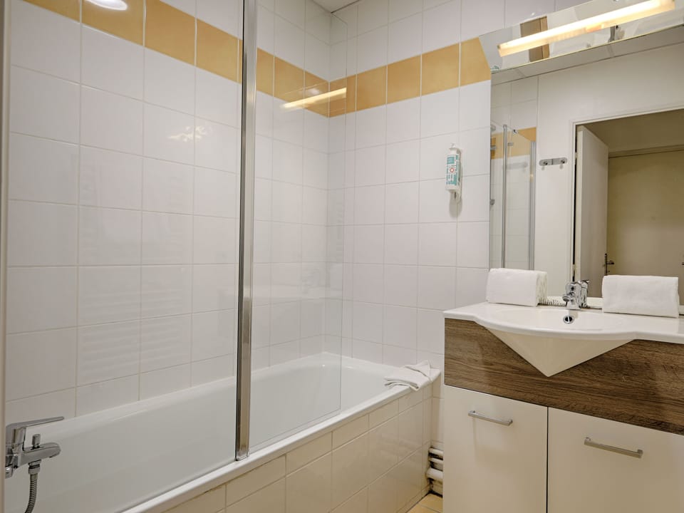 Sleek and modern bathroom with a walk-in shower, heated towel rail, and bright lighting for a spa-like experience.