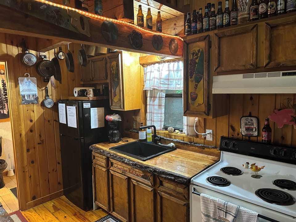 Kitchen, including skillets, pots, pans, toaster, microwave, coffee pot, dishes