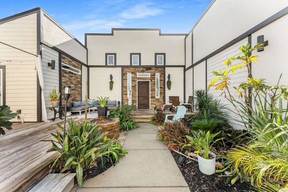 Beautifully landscaped area that is shared with seating at entrance of condo