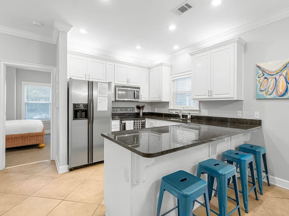 Spacious bar top seating and full kitchen